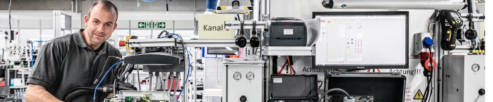 Baumer hhs employees in production building a hot melt gluing unit