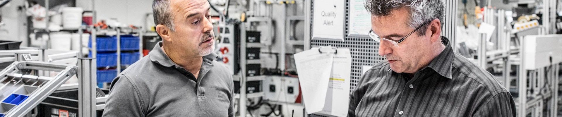 Two Baumer hhs employees communicate in production